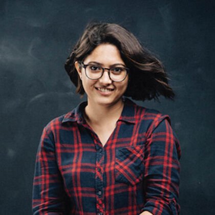 Archie in glasses and a plaid shirt